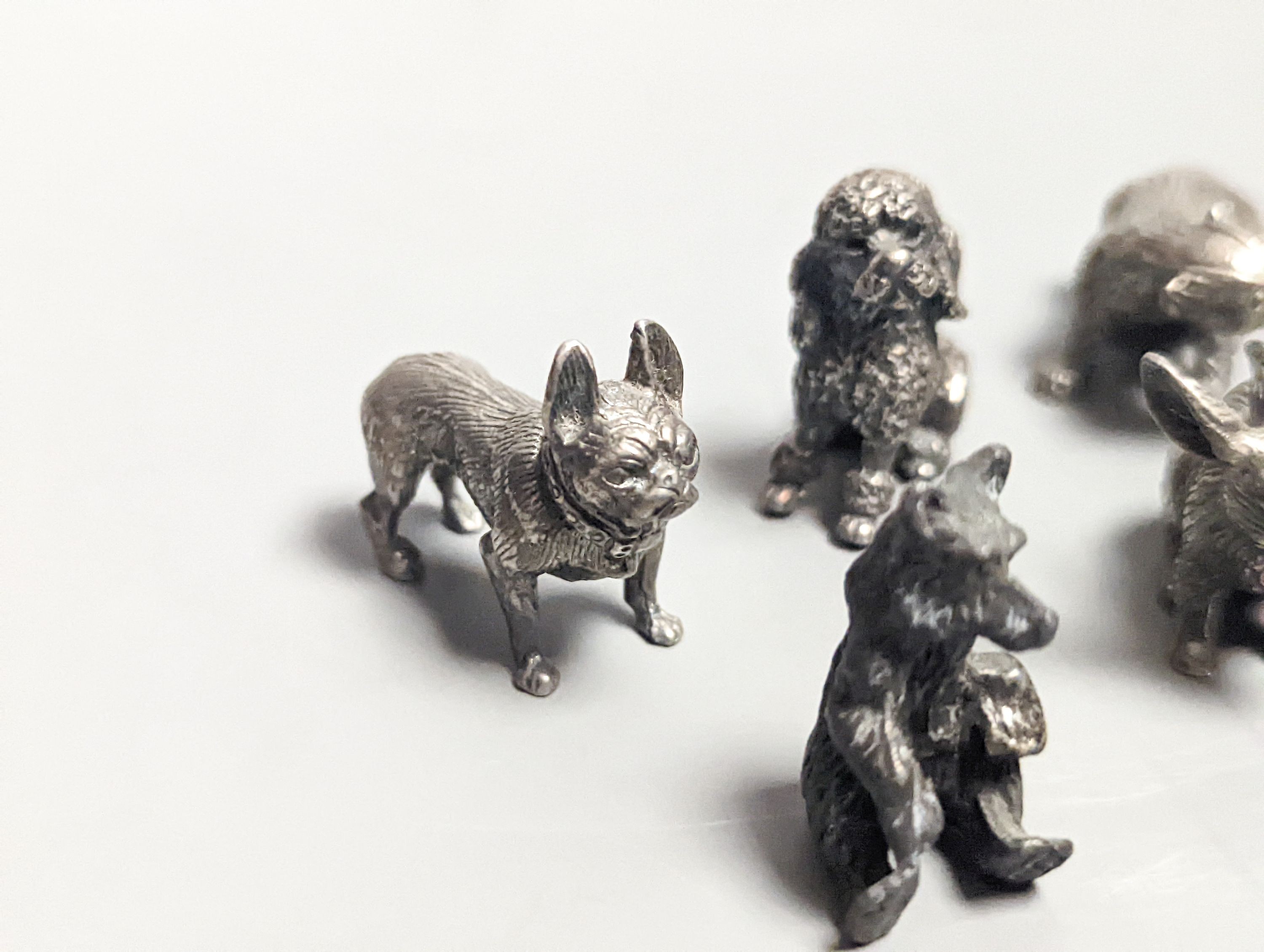 Four modern miniature freestanding model animals, including, badger, two dogs and a cat, JJSM, London, 1989 &1991, cat length 37mm, two Italian 925 models and two base metal models.